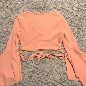 Pink cropped flare long sleeve top with wrap around waist straps